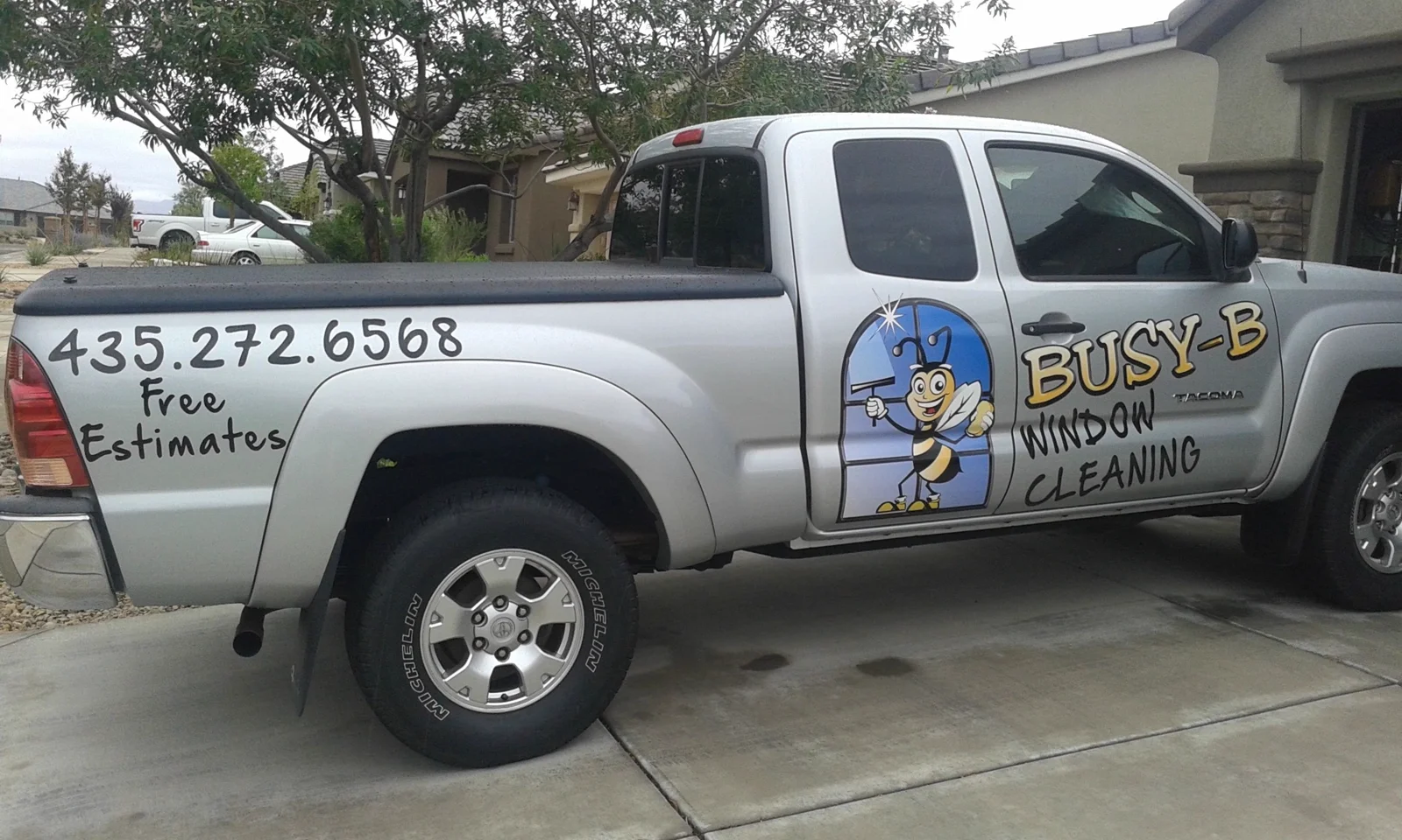 Busy B Window Cleaning truck with the business name and phone number