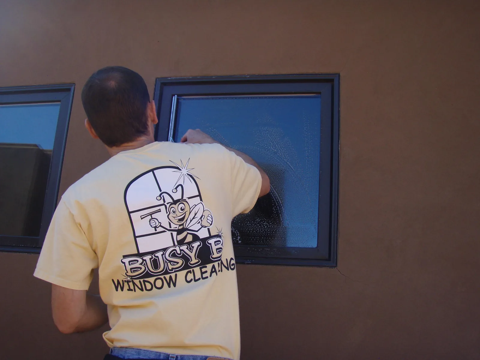 Jim detailing a window on a stucco wall, 2013.