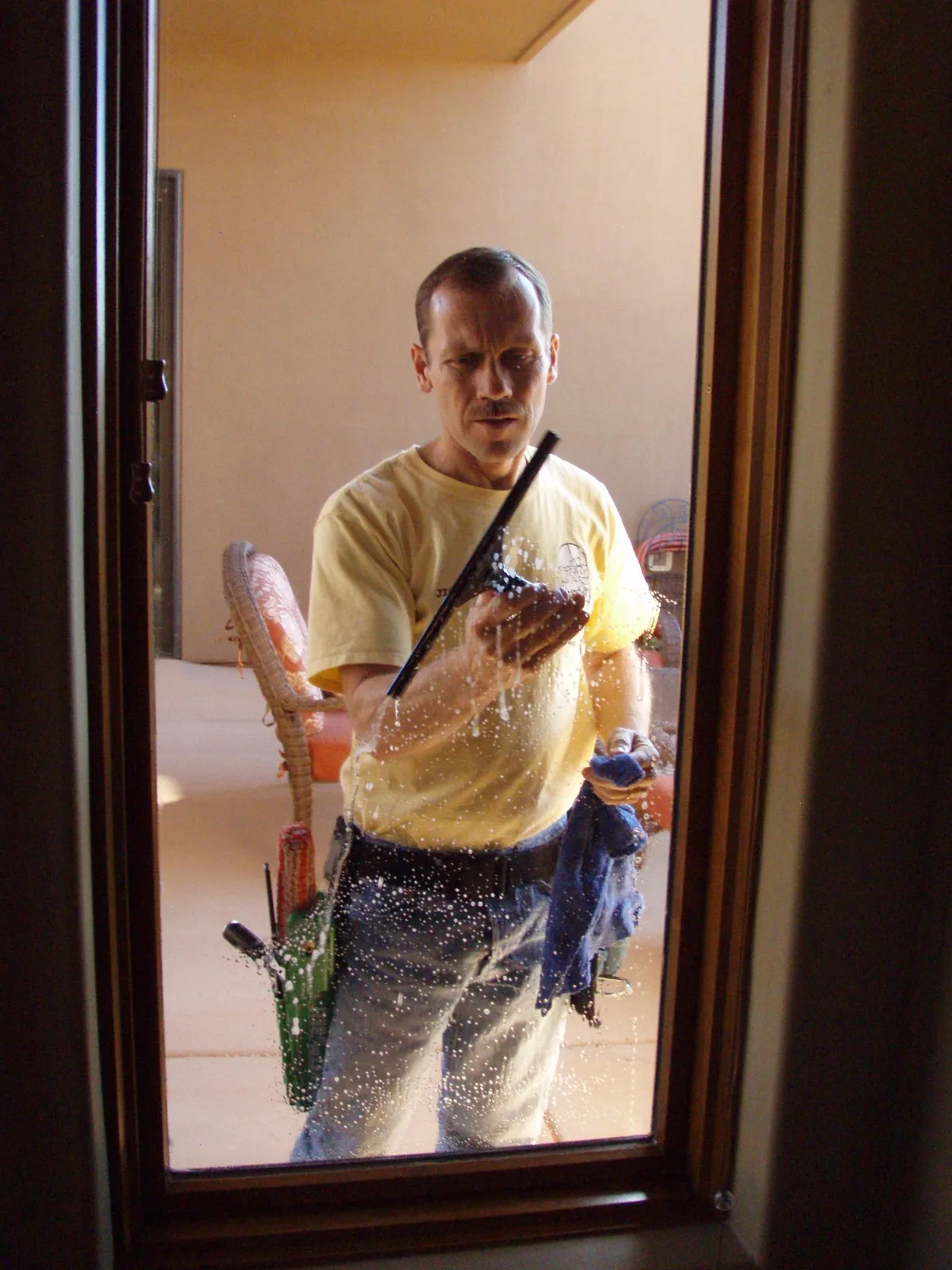 Jim working a door pane with a squeegee.