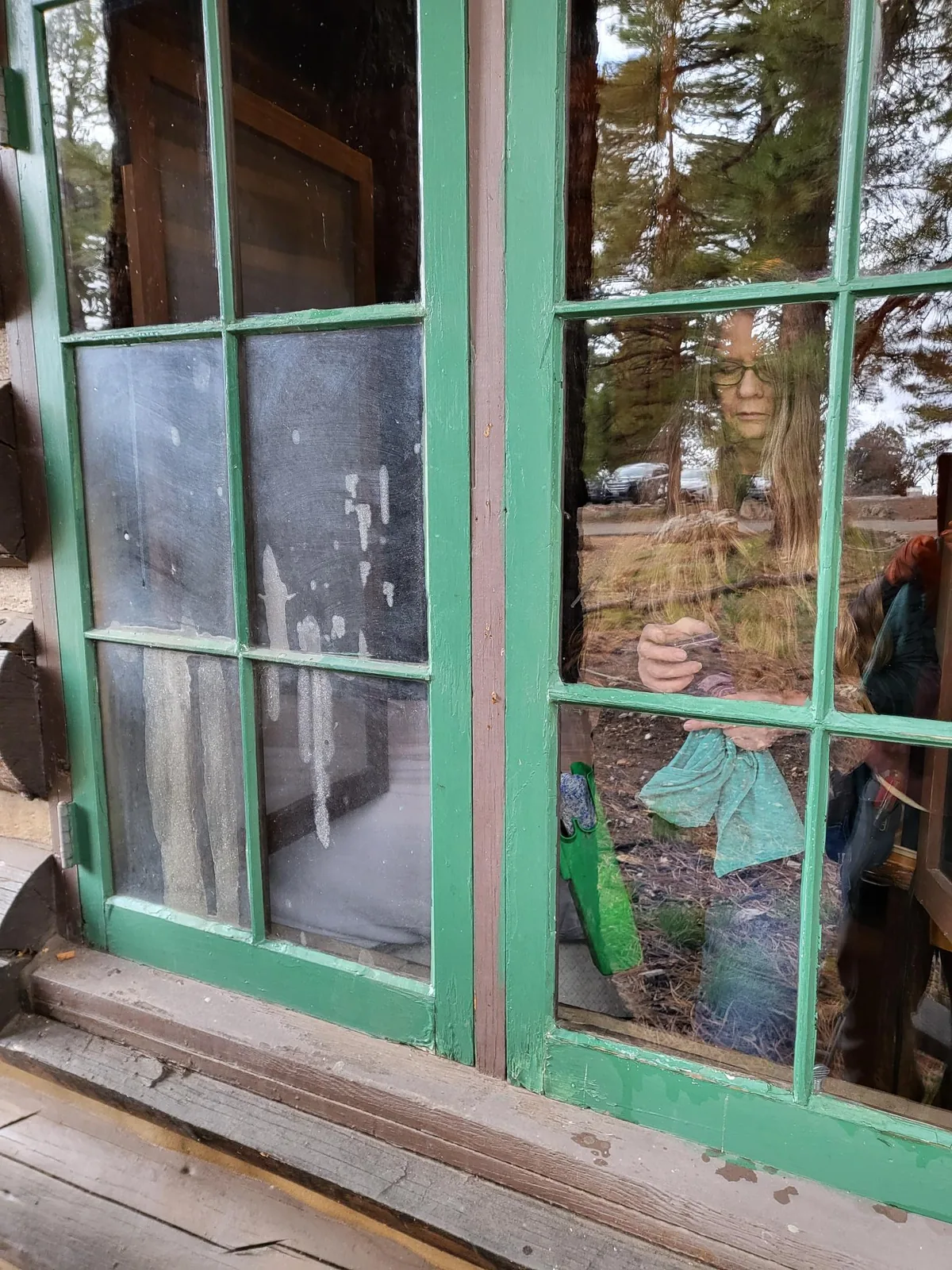 Lodge window with dirty, streaked panes on the left and cleaned panes on the right