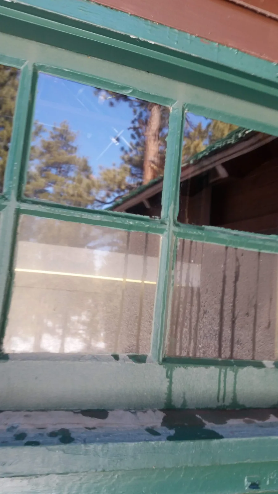 Streaks and drips on lodge glass before the work starts.